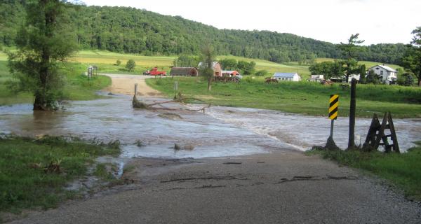 floodwaters washing out road